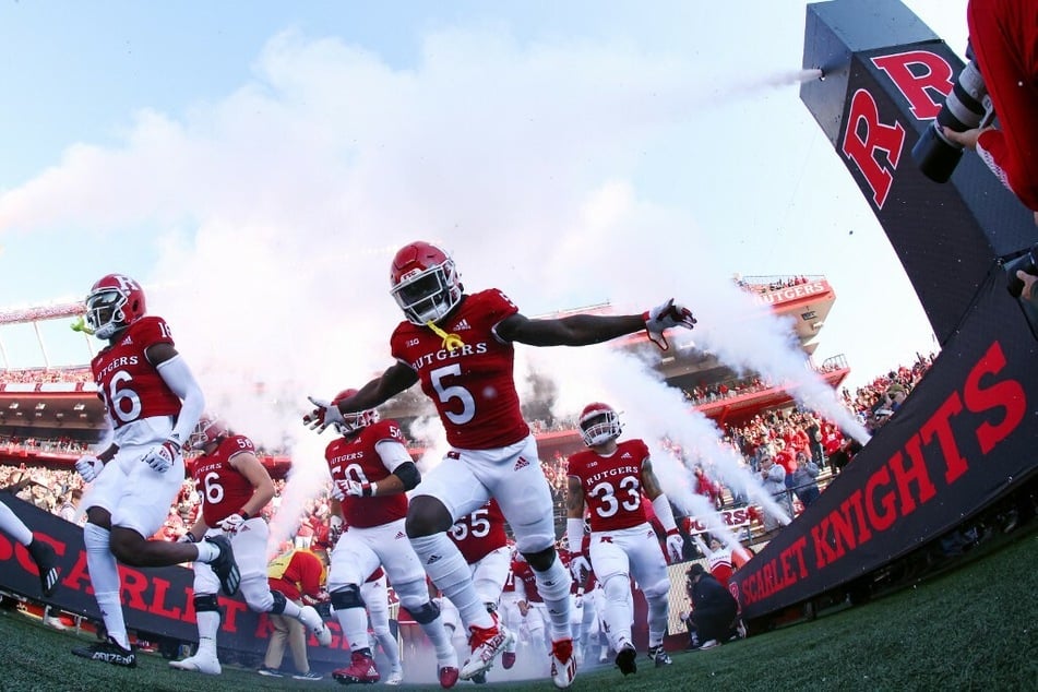 The Rutgers Scarlet Knights run onto the field before a game at SHI Stadium.