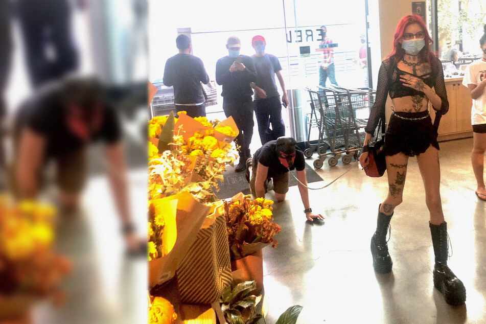 Dominatrix walks man on a leash while shopping at the supermarket