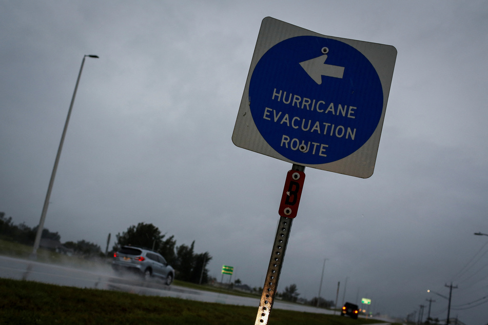 A hurricane evacuation route sign is displayed in Punta Gorda, Florida, as Hurricane Ian spins toward the state carrying high winds, torrential rains, and a powerful storm surge.