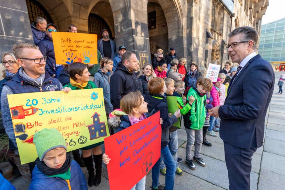 Bürgermeister Ralph Burghart (49, CDU) sprach mit protestierenden Eltern und Schülern vor dem Rathaus. Sie kämpfen für eine grundhafte Sanierung der Grundschule Klaffenbach.