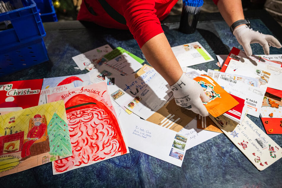 Gloomy skies aside, Santa Claus's Post Office in Santa Claus Village was bustling with activity, as red-hooded elves busily stamped cards and sorted piles of letters in the Christmas rush.