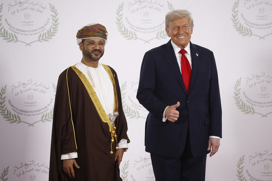 Oman's Foreign Minister Sayyid Badr Albusaidi (l.) and US President Donald Trump pose during a summit on Gaza in Sharm el-Sheikh, Egypt, on October 13, 2025.