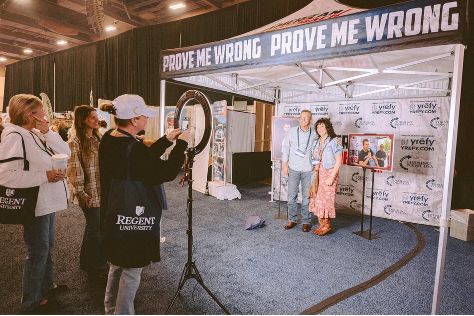 Fans of Charlie Kirk were seen at a recent Turning Point USA event celebrating his life by taking selfies in a replica of the tent he was killed in.