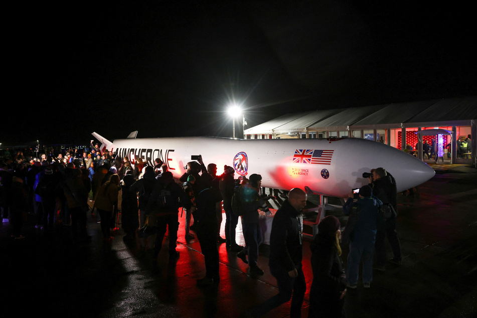 Spectators gather around a replica rocket at Cornwall Airport Newquay to watch the first ever UK launch of Virgin Orbit's LauncherOne rocket from Spaceport Cornwall.