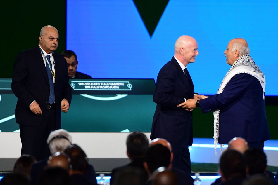 FIFA President Gianni Infantino (c.) interacts with the President of the Palestine Football Association Jibril Rajoub (r.) as the Vice-President of Israel Football Association Basim Sheikh Suliman (l.) looks on at the 76th FIFA Congress in Vancouver, Canada, on April 30, 2026.