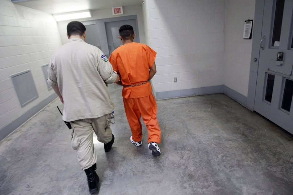 A Val Verde Correctional Facility officer moves an inmate from solitary confinement at the facility in Del Rio, Texas.