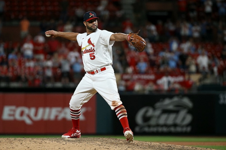Albert Pujols of the St. Louis Cardinals pitched during the ninth inning against the San Francisco Giants at Busch Stadium in St. Louis, Missouri on Sunday.