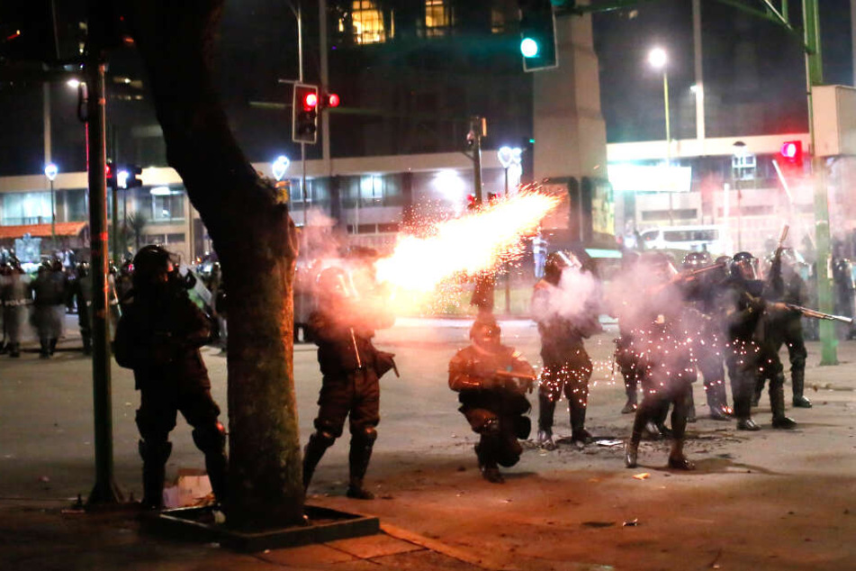 Die Polizei feuert mit Tränengas um sich.