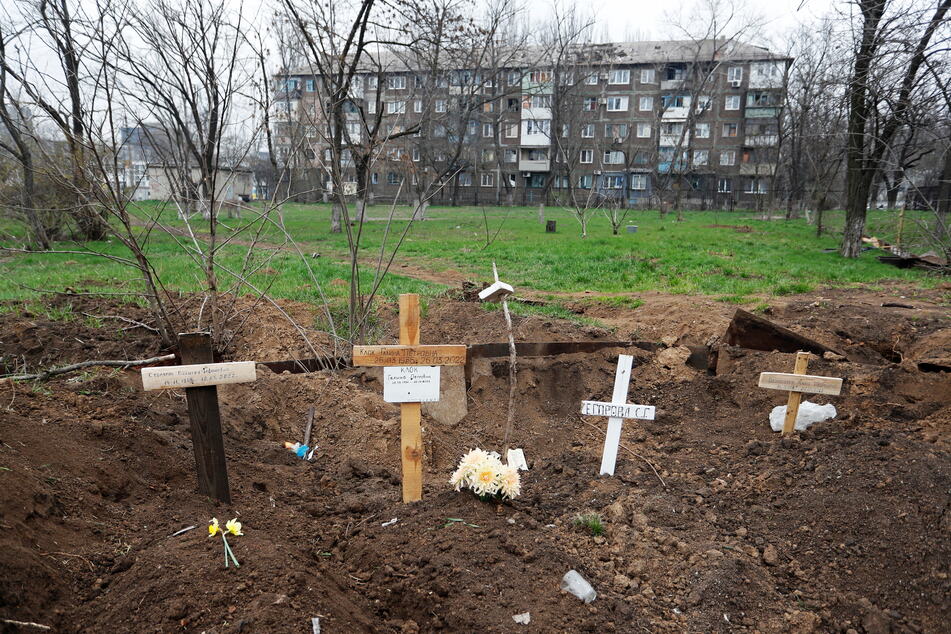 Crosses are placed at a burial site of local residents who died during Ukraine-Russia conflict in the southern port city of Mariupol, Ukraine. (REUTERS/Alexander Ermochenko)