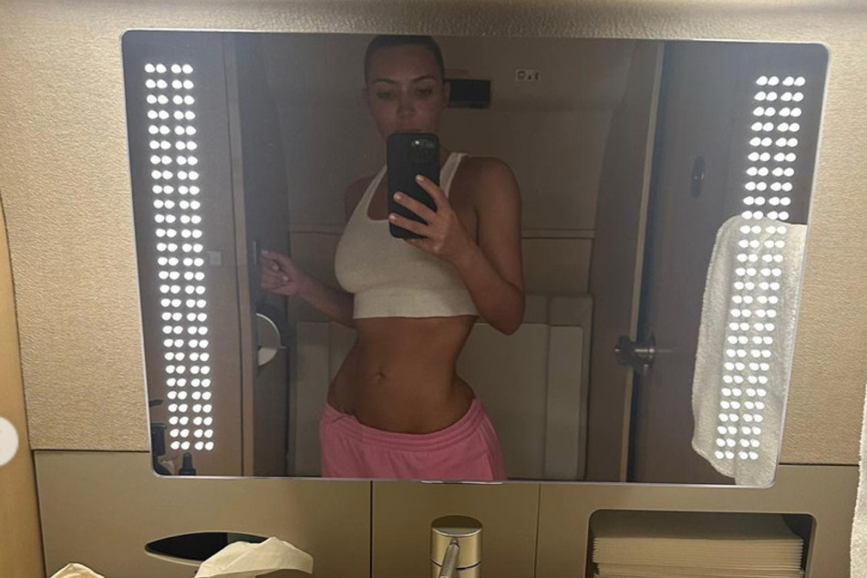 Kim Kardashian flashed her teeny waist on Instagram while jetting off in her private plane.