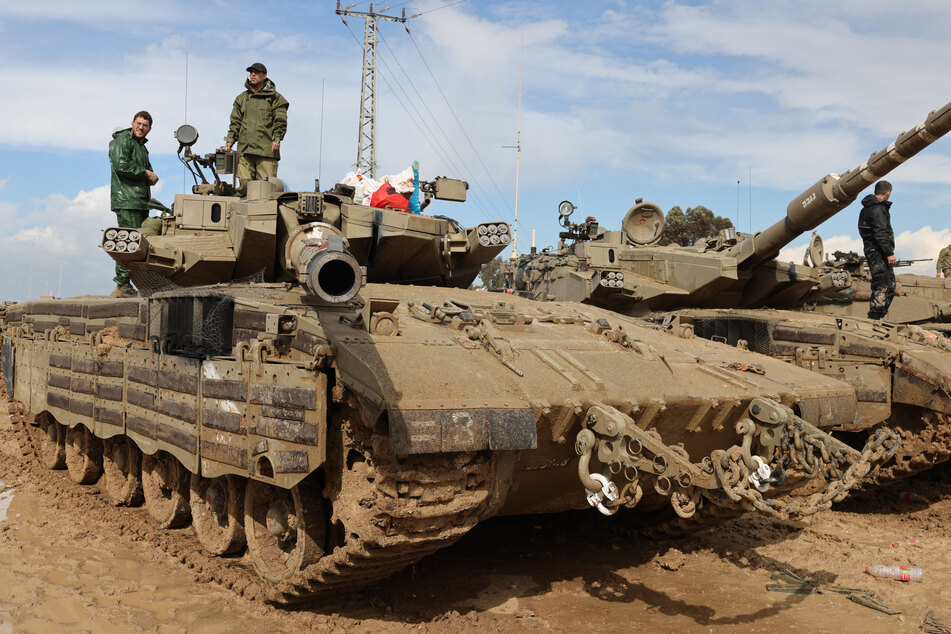 Israeli troops and tanks are stationed along the border with the Gaza Strip on Friday as battles continue between Israel and the Palestinian Hamas movement.