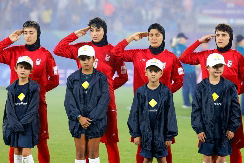 The Iranian soccer players went on to salute and sing the anthem when it played in subsequent games.