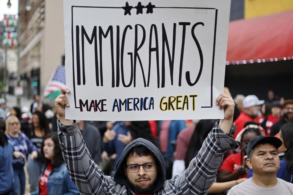 A protester holds a sign reading "Immigrants Make America Great" during a March for Dignity in Los Angeles, California, on March 1, 2025.