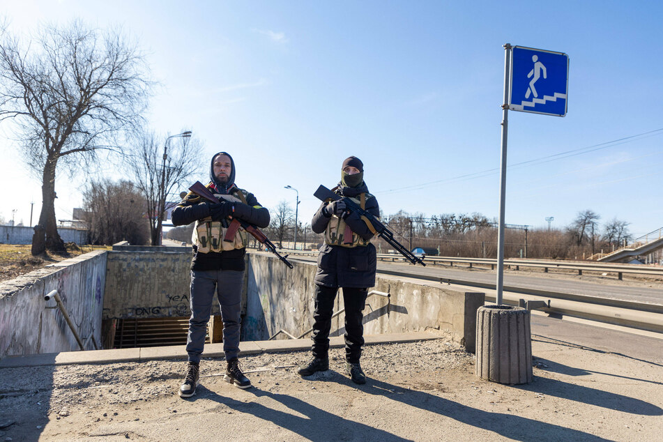 Ukrainian civilian soldiers stand guard in Kyiv, Ukraine.