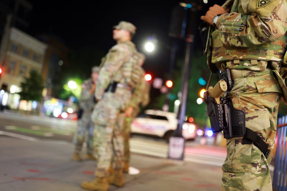 Members of the Ohio National Guard wear their sidearms while patrolling in the Logan Circle neighborhood of Washington DC on August 24, 2025.