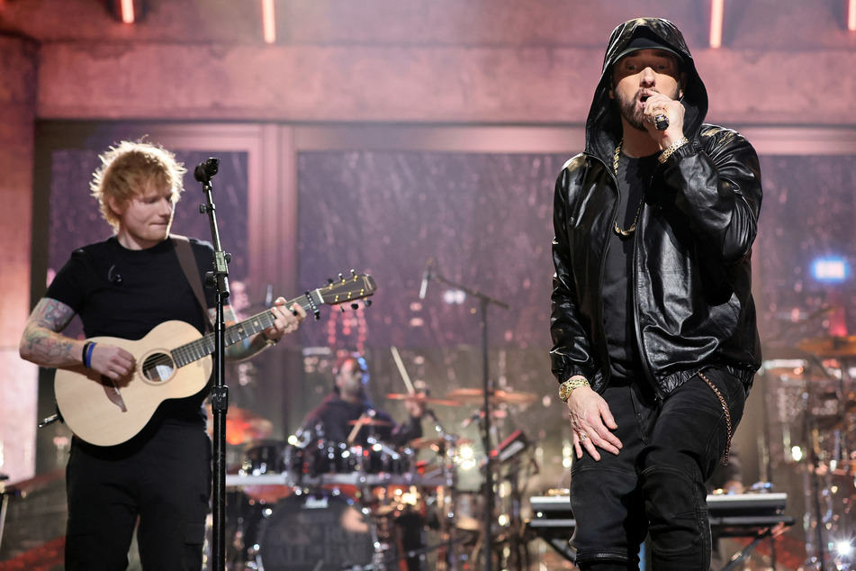 Rapper Eminem (r.) was inducted into the Rock &amp; Roll Hall of Fame, and gave a speech reflecting on the hard road it took to get to the top. He then performed alongside guest singer Ed Sheeran (l.) and others.