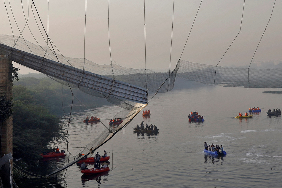 The aftermath of the bridge collapse in Morbi, India, as rescue workers search for survivors.