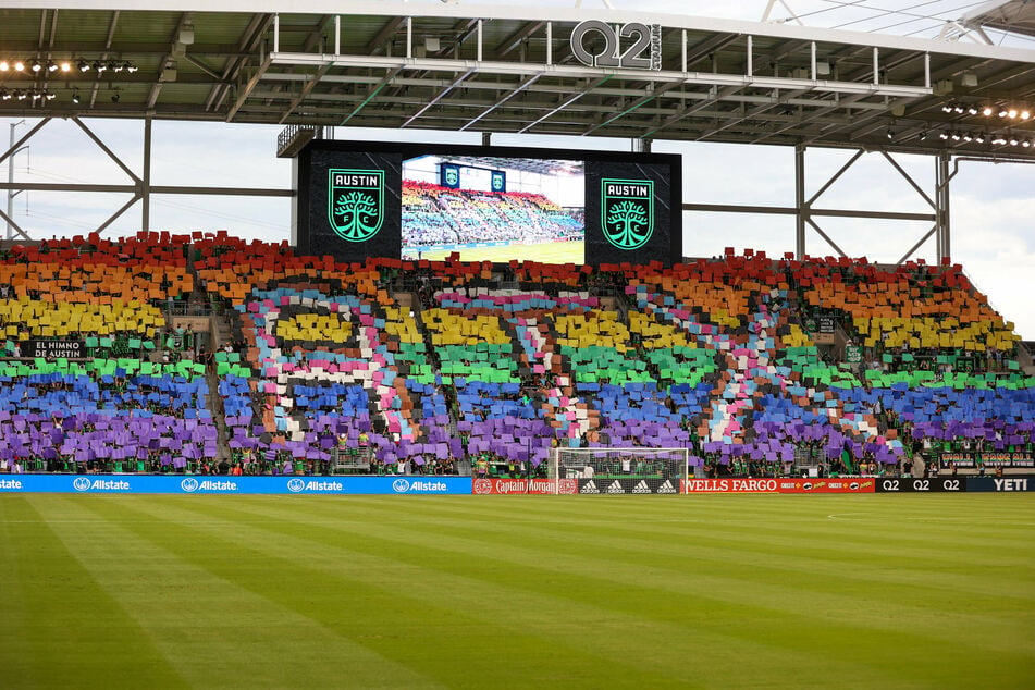 Austin FC supporters hold a rainbow of placards in recognition of Pride Month at Q2 Stadium before a match against Columbus Crew on June 27, 2021.