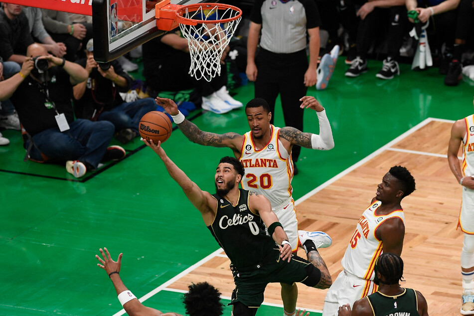 Boston Celtics forward Jayson Tatum (c. in black) shot against the Atlanta Hawks during Game 1 of the 2023 NBA playoffs on Saturday.