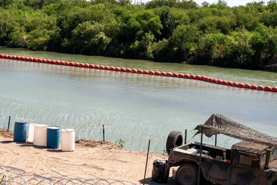 A string of buoys is placed on the water along the Rio Grande border with Mexico in Eagle Pass, Texas, to deter migrants from crossing.
