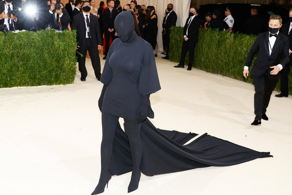 Kim Kardashian rocked a full-body covering, hiding her face with a black mask alongside a matching bodysuit.