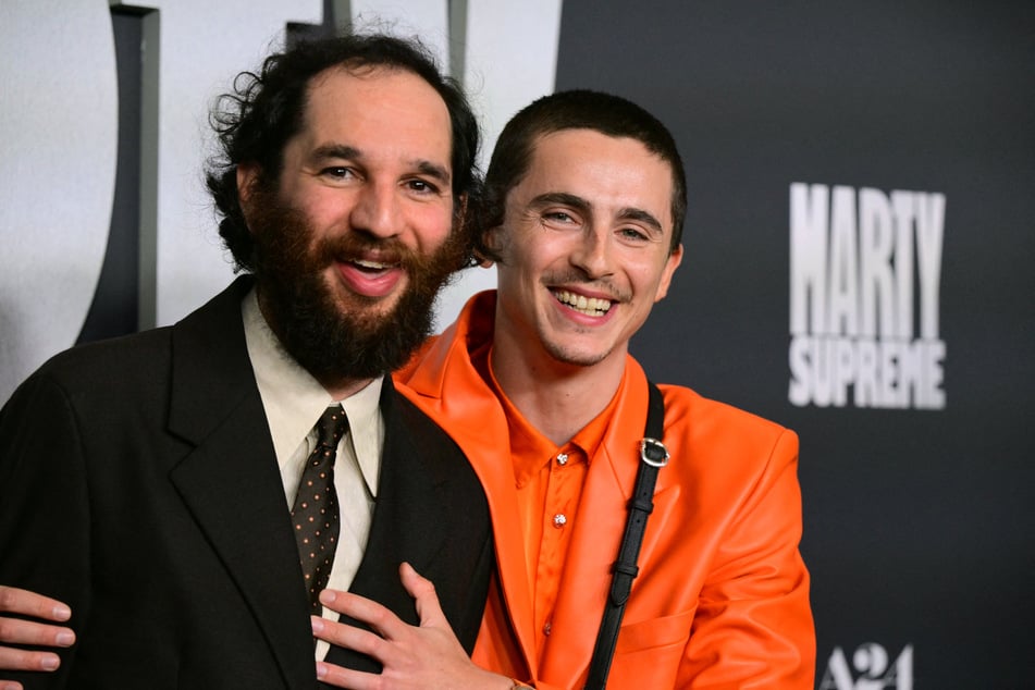 Actor Timothee Chalamet (R) and director Josh Safdie (L) attend the premiere of Marty Supreme in Los Angeles, California, on December 8, 2025.