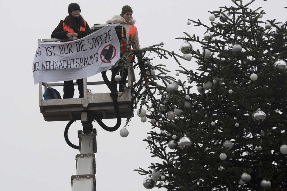 Zack ist die Spitze des Weihnachtsbaums vor dem Brandenburger Tor ab. Klimaaktivisten wollen damit auf eine noch viel größere Klimakatastrophe aufmerksam machen.