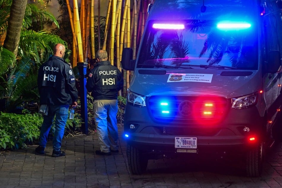 Homeland Security Investigation agents are seen at the entrance of Sean "Diddy" Combs' home at Star Island in Miami Beach on March 25, 2024.