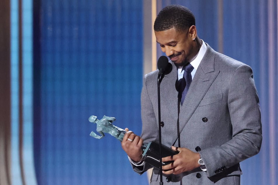 Michael B. Jordan accepts the award for Male Actor in a Leading Role for Sinners during the Actor Awards in Los Angeles, California, on March 1, 2026.