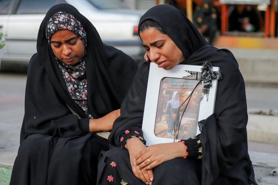 People mourn on the day of the funeral of the victims of a strike on a school in Minab, Iran, on March 3, 2026.