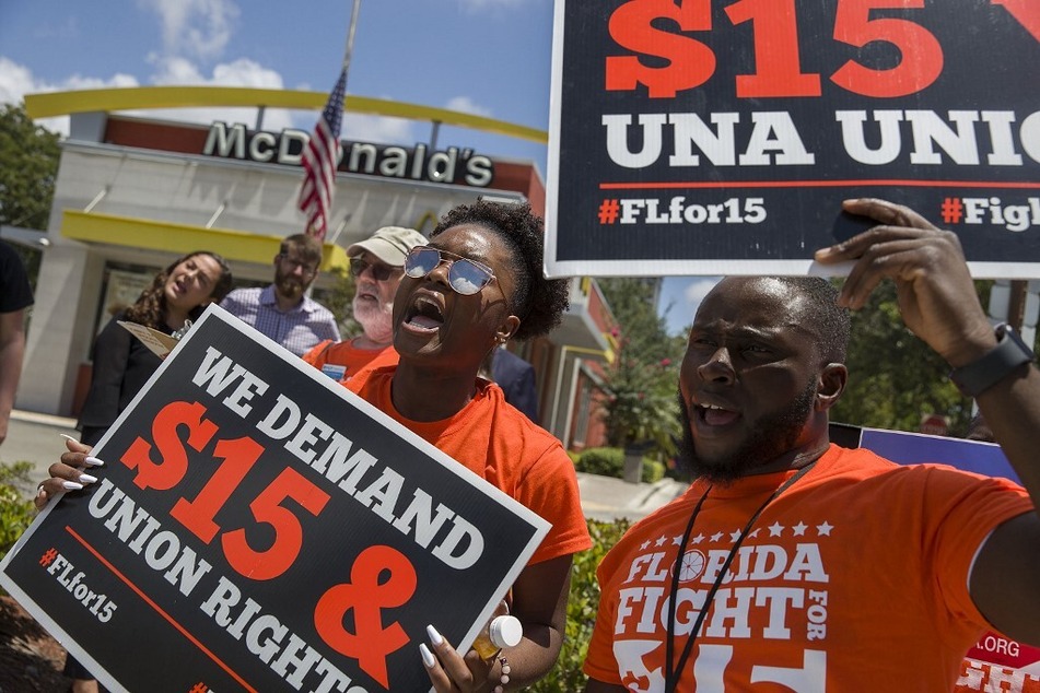 People rally outside a McDonald's location in Fort Lauderdale, Florida, to demand a minimum wage of at least $15 an hour and union rights.