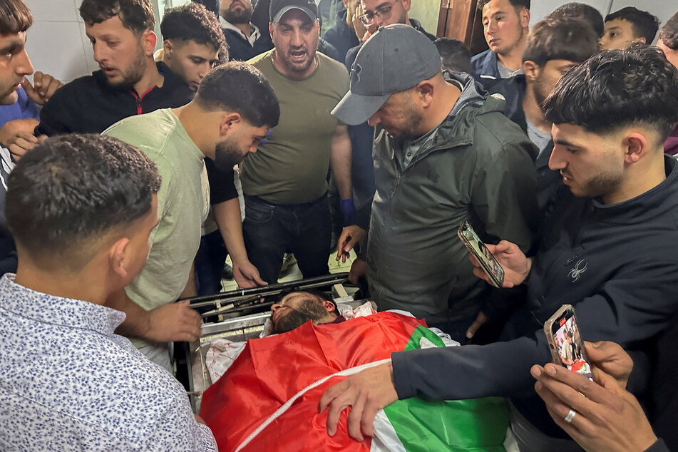 Palestinians mourn Tawfiq Ajaq, a 17-year old Palestinian-American who was reportedly killed by Israeli forces, in a hospital in Ramallah in the Israeli-occupied West Bank on January 19,2024.