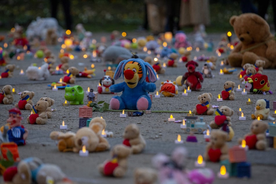 Teddy bears and toys representing children abducted during the war in Ukraine are seen on the ground during an event organized by Avaaz NGO and Ukrainian refugees at the Rond-point Schuman in Brussels on February 23, 2023, to mark the first anniversary of Russian invasion of Ukraine.