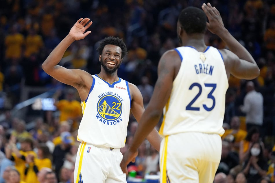 Andrew Wiggins (l.) celebrates with Draymond Green during Game 5 of the NBA Finals.