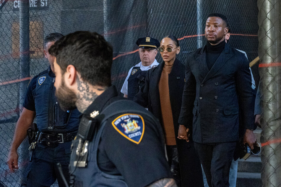 Actor Jonathan Majors (far r.) departs with girlfriend Meagan Good (c.) from his sentencing hearing in the domestic abuse case at Manhattan Criminal Court on Monday in New York City.