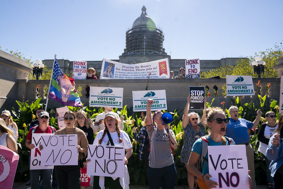 Pro-choice protesters encourage voters to vote "no" on Amendment 2 on the steps of the Kentucky State Capitol in Frankfort on October 1, 2022.