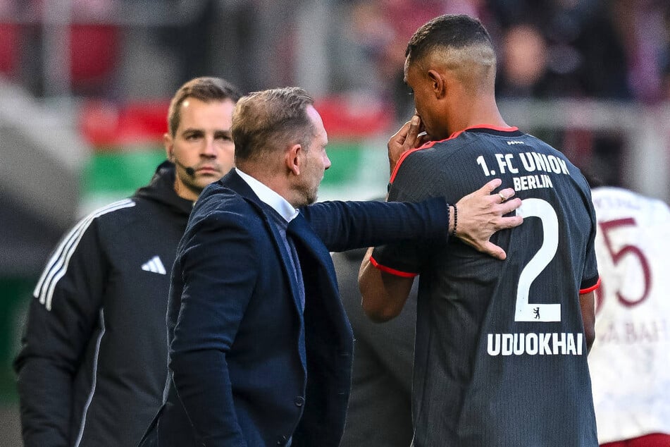 Union-Coach Mauro Lustrinelli (M.) tröstet den unglücklichen Felix Uduokhai (r.) nach dessen Platzverweis.
