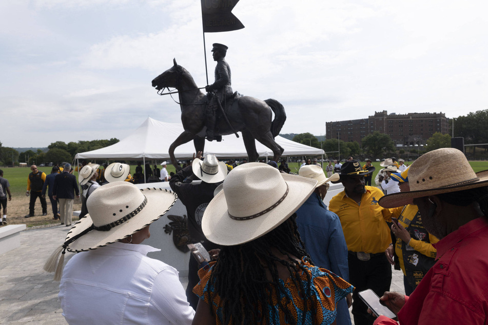 Members of the Federation of Black Cowboys look at the Buffalo Soldier Statue during the annual Buffalo Soldiers Association of West Point awards ceremony.