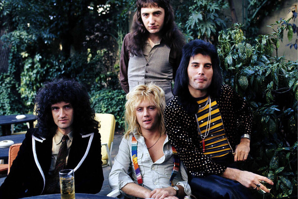 Queen members (from l. to r.) Brian May, John Deacon (standing c.), Roger Taylor (bottom c.), and Freddie Mercury released their hit single Bohemian Rhapsody in 1975, heralded as one of the greatest songs of all time.