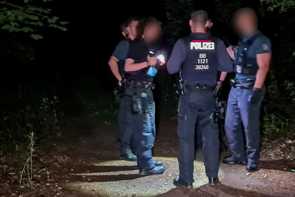 Polizisten suchen das Gebiet ab.