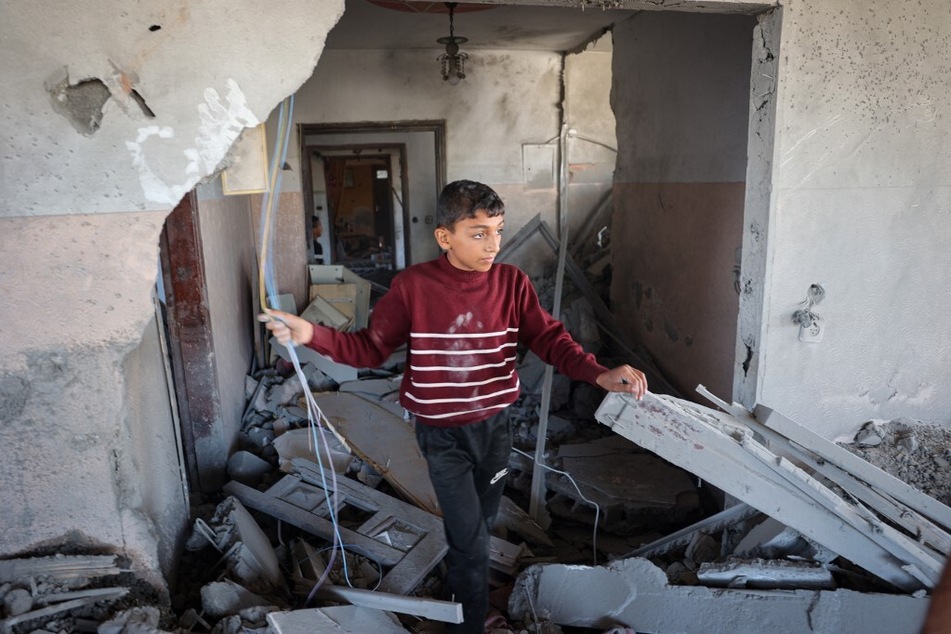 A Palestinian child checks the rubble of a house hit by overnight Israeli bombing in Rafah in the southern Gaza Strip on April 20, 2024.