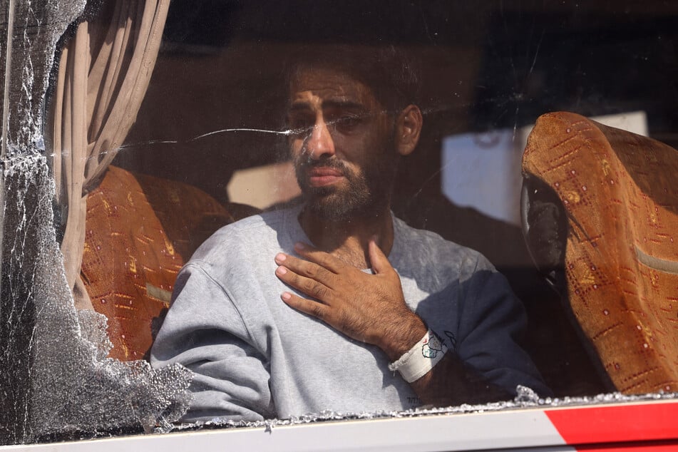 A Palestinian man released from Israeli prison arrives on a bus outside the Nasser hospital in Khan Younis on October 13, 2025.