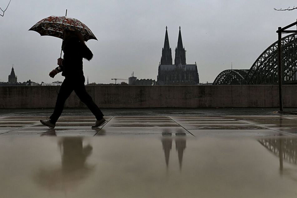 Ein Fußgänger mit Schirm in Köln.
