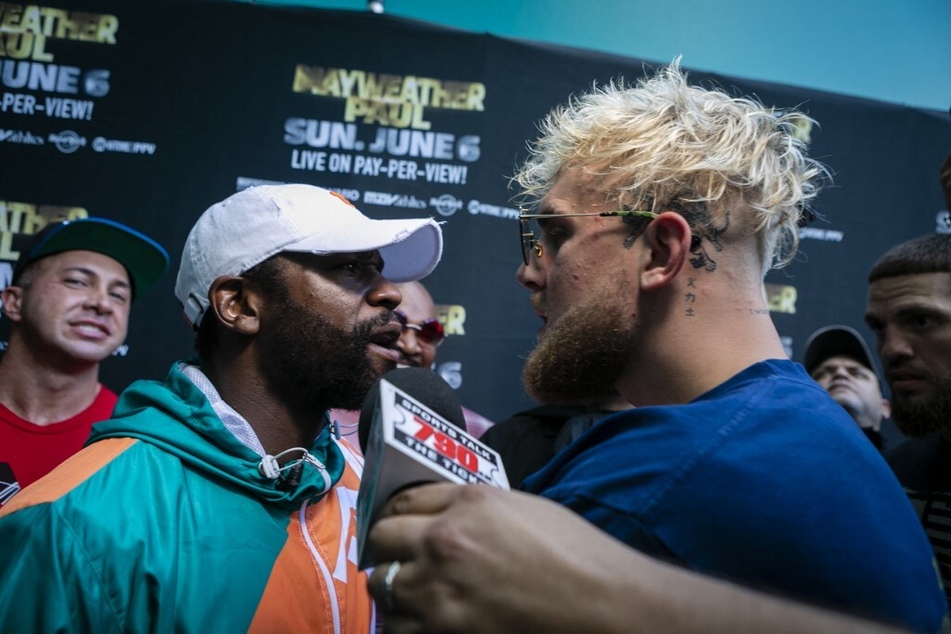 On Wednesday night, YouTuber-turned-boxer Jake Paul (r) ran for his life after being confronted by Floyd Mayweather (l).