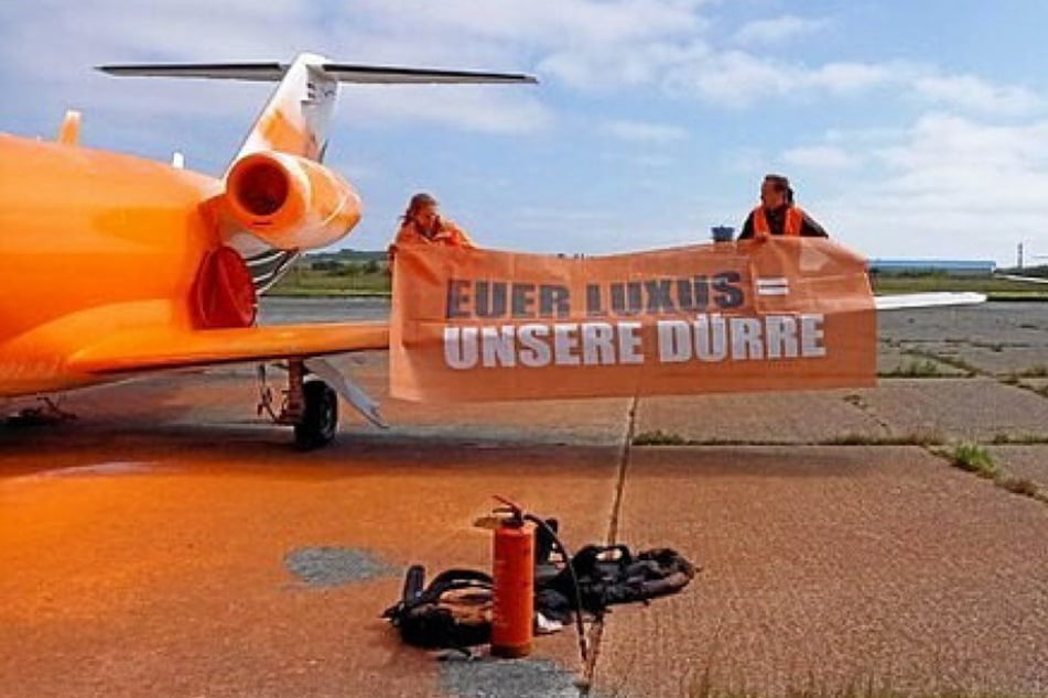 Die Klimaaktivisten besprühten das Flugzeug mit greller Farbe und entrollten ein Banner.