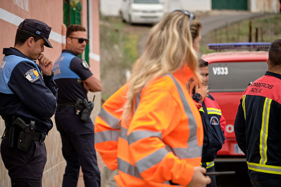 Feuerwehrleute und Polizeikräfte bei einem Einsatz am Tatort.