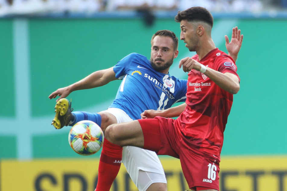 1. Runde, DFB-Pokal: Rostocks Pascal Breier (l) kämpft mit Stuttgarts Atakan Karazor um den Ball.