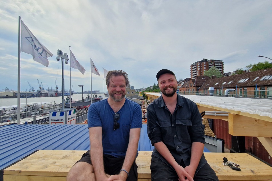 Die Betreiber Björn Hansen (44, l.) und Kevin Hartjen (33) über den Dächern ihres neuen Beachclubs "Sonnendeck" an den Hamburger Landungsbrücken.