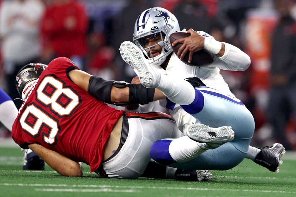 Dak Prescott (r.) struggled in his season opener against the Tampa Bay Buccaneers on Sunday, and left the game after fracturing his thumb. He had surgery on Monday.