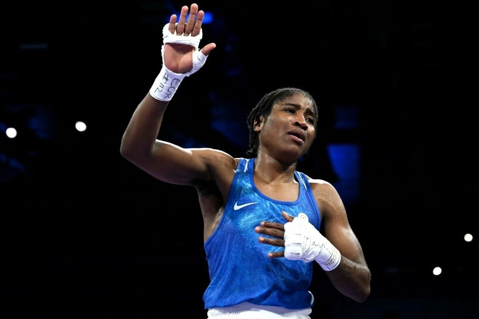 The Olympic Refugee Team's Cindy Winner Djankeu Ngamba celebrates after winning against Canada's Tammara Amanda Thibeault in the women's 75kg preliminaries round of 16 boxing match during the Paris Games.